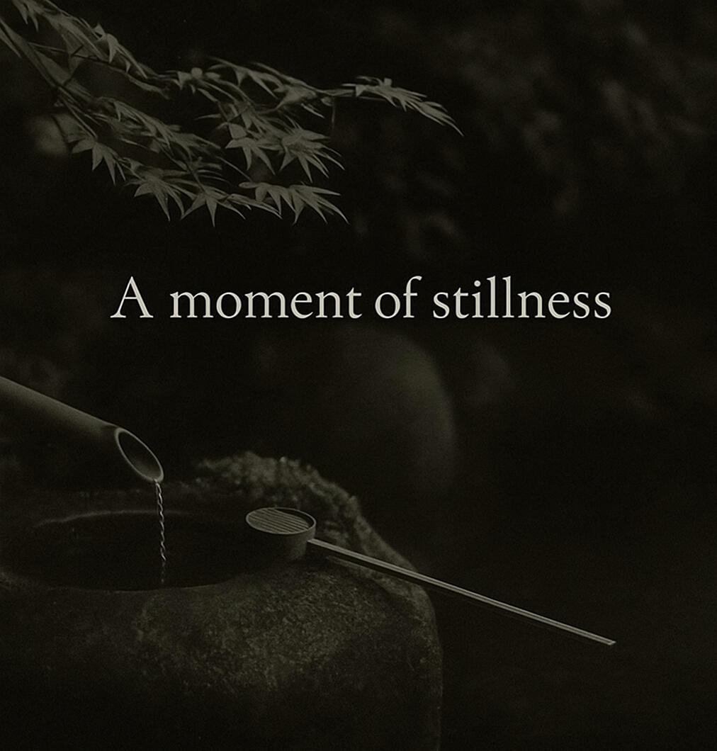 Japanese stillness Bamboo ladle with dripping water on a stone basin